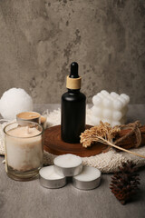 Black Dropper Bottles with Natural Spa Accessories on Rustic Background