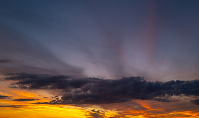 Obraz premium Sunrise sky background. Dramatic scenery sunset. Sky with clouds in Sunrise sky light background. Sunrise with clouds in various shapes. Calm Sunrise sky and sun through clouds over.
