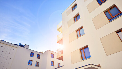 Modern apartment buildings on a sunny day with a blue sky. Facade of a modern apartment building. Contemporary residential building exterior in the daylight. 