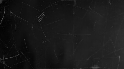 Rough, gritty black surface with scattered scratches and smudges, dirty, surface