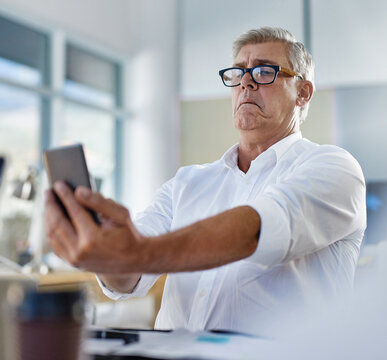 Mature man, phone and vision problem, eyesight and myopia or glaucoma in business office. Mobile, person and poor sight, squinting and manager struggle with reading blurry email online with glasses
