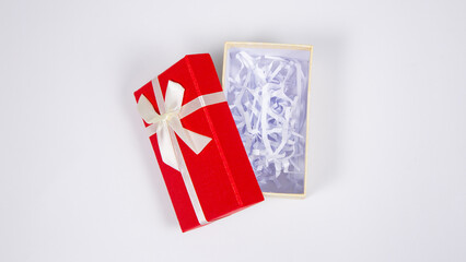 Open a gift box with a red lid and a yellow box wrapped by ribbon with tied bow isolated on white background. Presents and gift boxes for festivals and celebrations. Mockup for design.