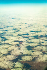 Looking from the window of plane to see clouds and land