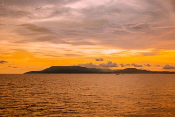 Sunset with dramatic clouds on tropical beach