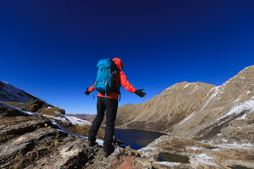 Hiking woman on high altitude mountain top