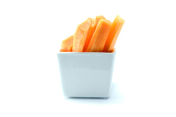 Group of fresh long cut carrot stick in rectangular cup isolated on white background close up...