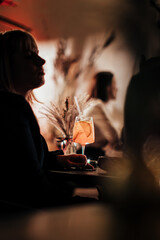 Silhouette of Woman Relaxing with Cocktail at Lounge