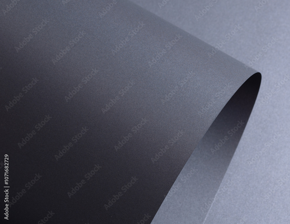 Aufkleber Designer paper background with a dark gray, graphite texture featuring wavy, curved shapes and a subtle gradient. The crinkled, twisted surface adds depth, while fine layers and