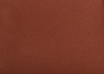 Designer paper background with a rich, velvety matte texture in warm earthy tones like terracotta,...