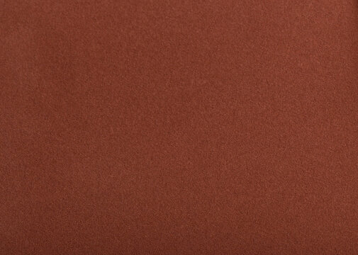 Designer paper background with a rich, velvety matte texture in warm earthy tones like terracotta, ochre, and cinnamon. This soft, gradient surface has a chic, vintage appeal with