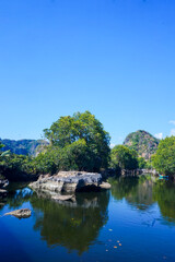 Fototapeta premium Maros Rammang-Rammang, panoramic views of clear rivers and shell rocks overlooking trees and mountains