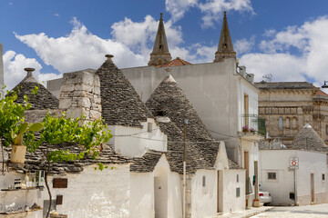 Via del Gesu with trulli houses, traditional Apulian dry stone hut with a conical roof, Alberobello, Apulia, Italy