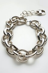 Fototapeta premium Silver chain bracelet lying on white background, intricate design with delicate links
