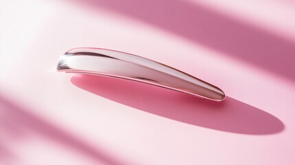 Classic silver hair clip with a sleek finish, isolated on pastel pink background, symbolizing style