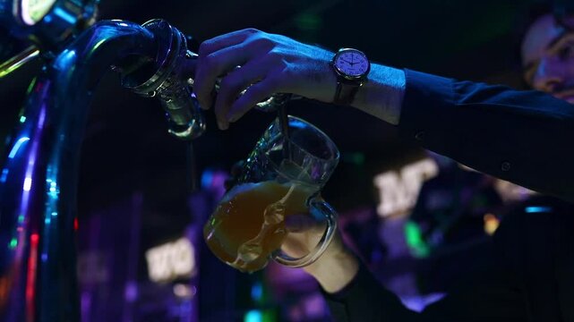 Bartender pouring beer at the bar. Close up hands	
