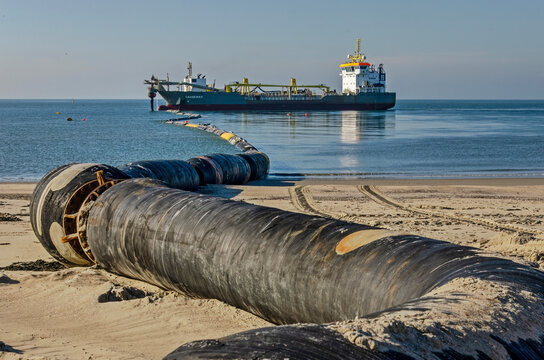 Westenschouwen, The Netherlands, October 26, 2024: pipeline leading from a hopper dredger off the cost towards the beach during coastal defense works