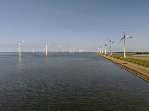 Windmills park in the sea near the coast of the flevopolder in the Netherlands