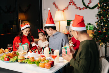 Celebrate Christmas with family in a cozy, festive setting. Santa hats, gifts, and delicious food capture the warmth, joy,