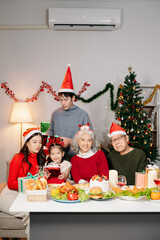 Celebrate Christmas with family in a cozy, festive setting. Santa hats, gifts, and delicious food capture the warmth, joy,