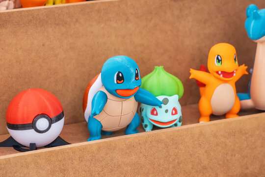 13 October 2024, Belgrade, Serbia: Colorful Pokemon toy figures with Pokeball on a wooden shelf