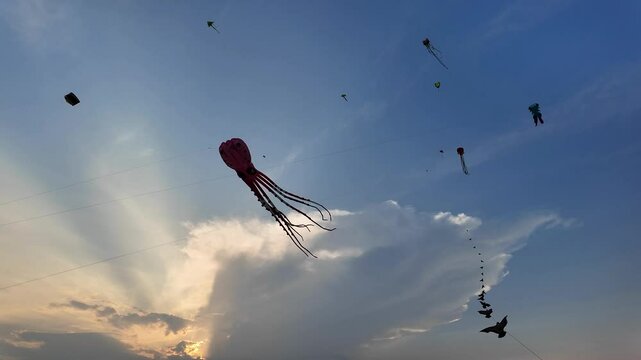 Colorful kites soar against a dramatic evening sky, symbolizing freedom and festivals like Makar Sankranti