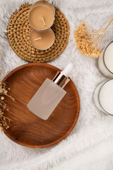 Frosted Glass Dropper Bottles with Natural Elements on Fluffy White Background