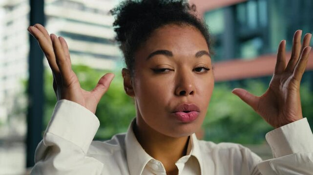 Shocked African American woman female girl businesswoman brainstorm headshot outdoors face brain head boom gesture problem overwhelmed mind expression emotions business city explosion bomb ethnic town