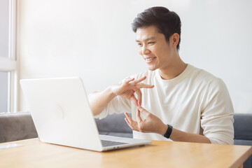 close up asian employee make gesture hand about help sign language to meeting and talking with team from webinar in home for office culture lifestyle concept	