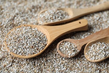 Different spoons with fresh rye bran, closeup