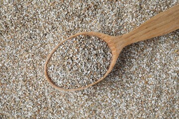 Spoon with fresh rye bran, top view