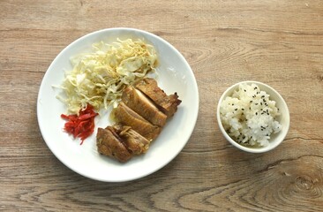 slice grilled chicken with Teriyaki Japanese sauce and chop cabbage on plate eat couple rice mixed sesame in cup