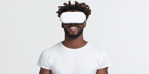 Young man enjoying virtual reality with a headset, smiling and engaged in the experience.