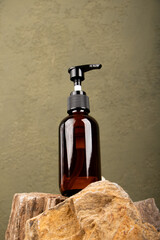Amber Pump Bottle for Skincare Products on Rustic Stone Background"