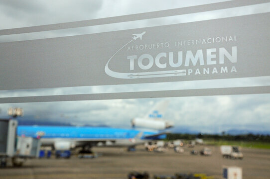 Panama City, Panama, June 04, 2021: Tocumen International Airport signage with a plane preparing for takeoff.  