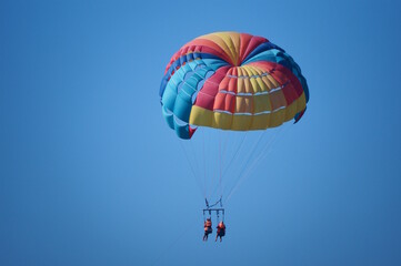 Parasailing. Parachute flight behind the boat. Vacation at the sea.
