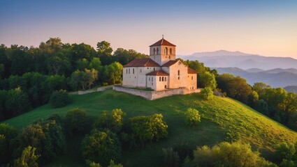Fototapeta premium Ancient Monastery on Verdant Hill at Dusk