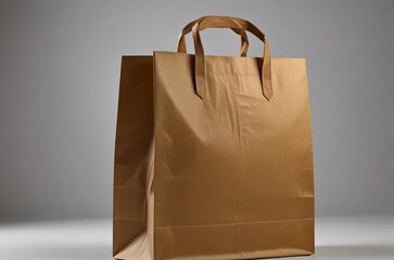A blank brown paper bag on a gray background
