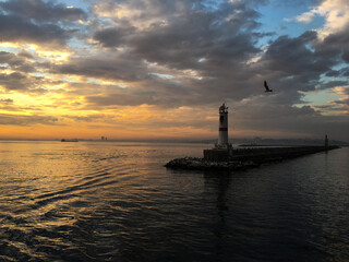 lighthouse at sunset, view from the water