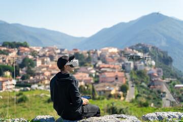The guy's launching a drone. Controlling the quadcopter