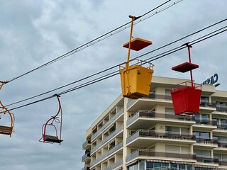 Unique urban cable chairlift over canal with colorful open-air gondolas in Palavas-les-Flots,...
