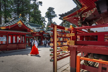 Hakone Shrine, with a lady passing by wearing traditional japanese clothes.