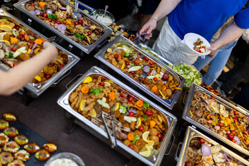 Lively buffet spread featuring a variety of colorful dishes at a social gathering in an indoor venue during the afternoon