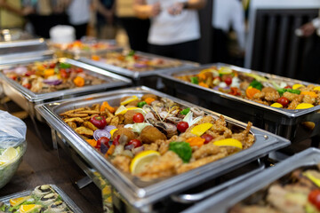 Vibrant buffet spread featuring a variety of dishes at a social gathering in a festive atmosphere