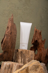 White Cosmetic Tube on Rustic Stone with Natural Wooden Elements for Skincare Branding