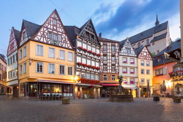 Morning view of the historic market square in Cochem with traditional half-timbered houses decorated with flowers, Germany