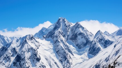 Obraz premium Majestic snow-capped peaks rise against a brilliant blue sky, exuding serenity and timeless beauty, evoking thoughts of adventure and exploration.
