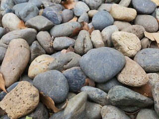 A collage of gray river rocks
