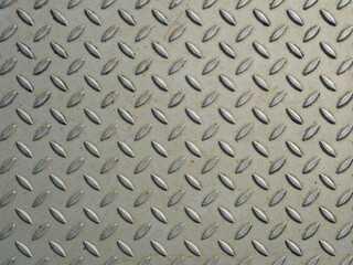 Fototapeta premium chequered plate - The surface of the checker plate with its precise grooves offers a beautiful texture. Ideal as a background for industrial or technical designs.