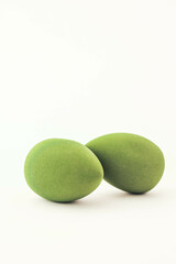 Green makeup sponges on a white background. A minimalist composition showcasing beauty tools for foundation blending, perfect for skincare and cosmetics themes