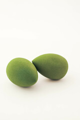 Green makeup sponges on a white background. A minimalist composition showcasing beauty tools for foundation blending, perfect for skincare and cosmetics themes